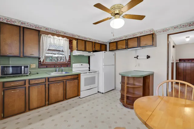 a kitchen with a sink appliances and cabinets