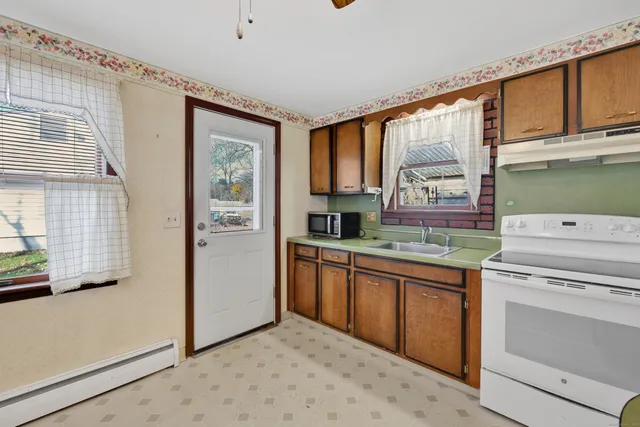 a kitchen with a stove a sink and a refrigerator