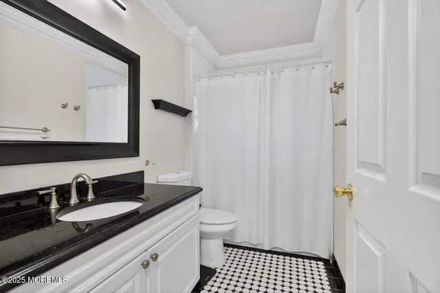 a bathroom with a sink a toilet a shower and a mirror