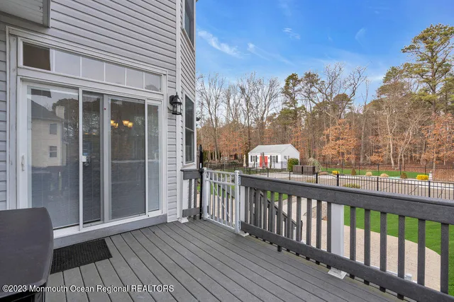 a view of a wooden deck with a yard