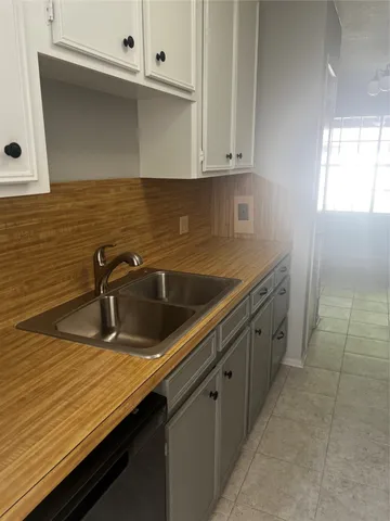 a view with a sink and cabinets