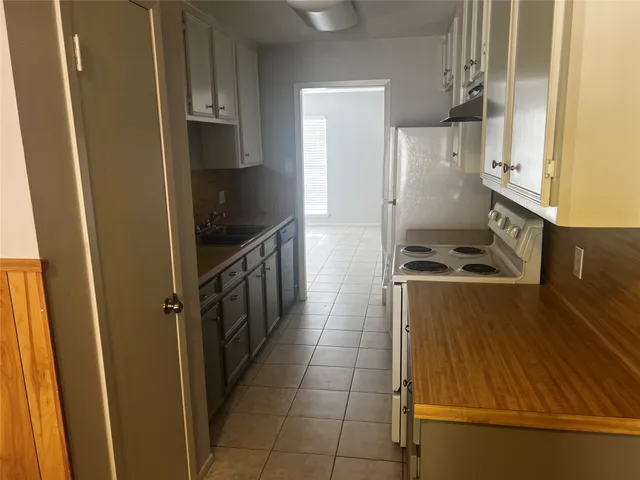 a kitchen with stainless steel appliances a refrigerator and a stove