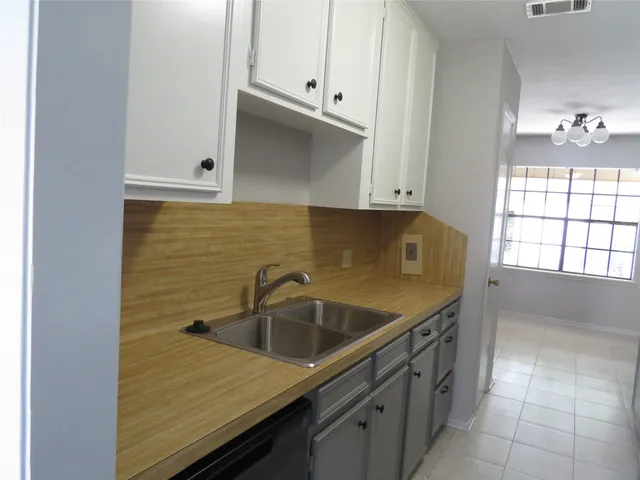 a kitchen with a sink and cabinets