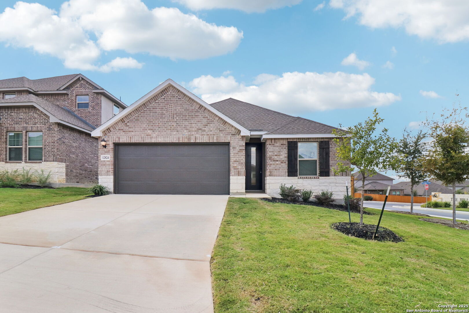 a front view of a house with a garden and yard