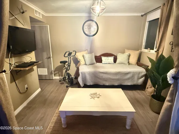 a bed room with two bed tv and a window