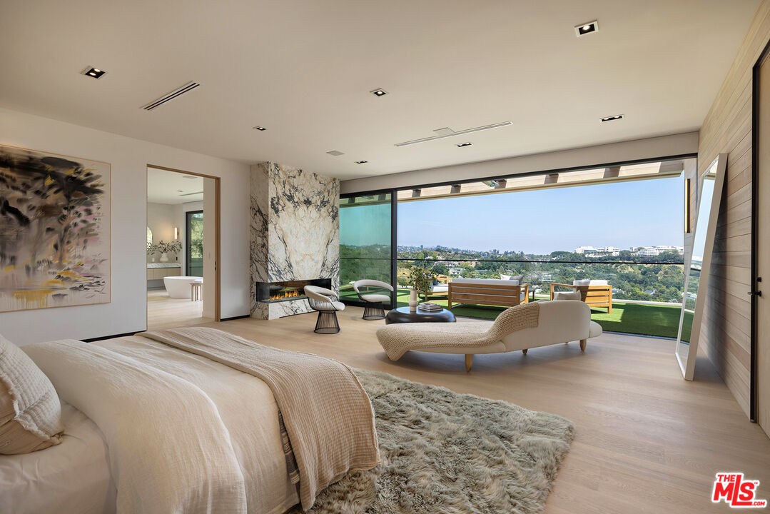 1104 North Tigertail Road Los Angeles, CA 90049 - Photo 12 of 27 a bedroom with furniture and a large window