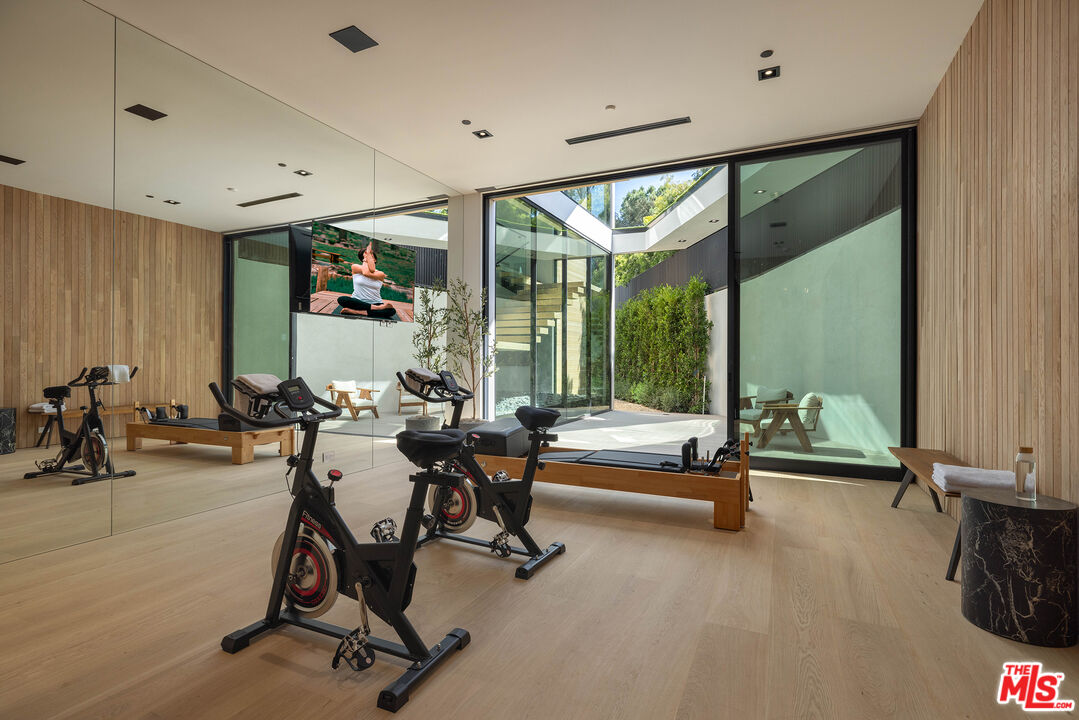 1104 North Tigertail Road Los Angeles, CA 90049 - Photo 14 of 27 a living room with furniture gym equipment and a large window