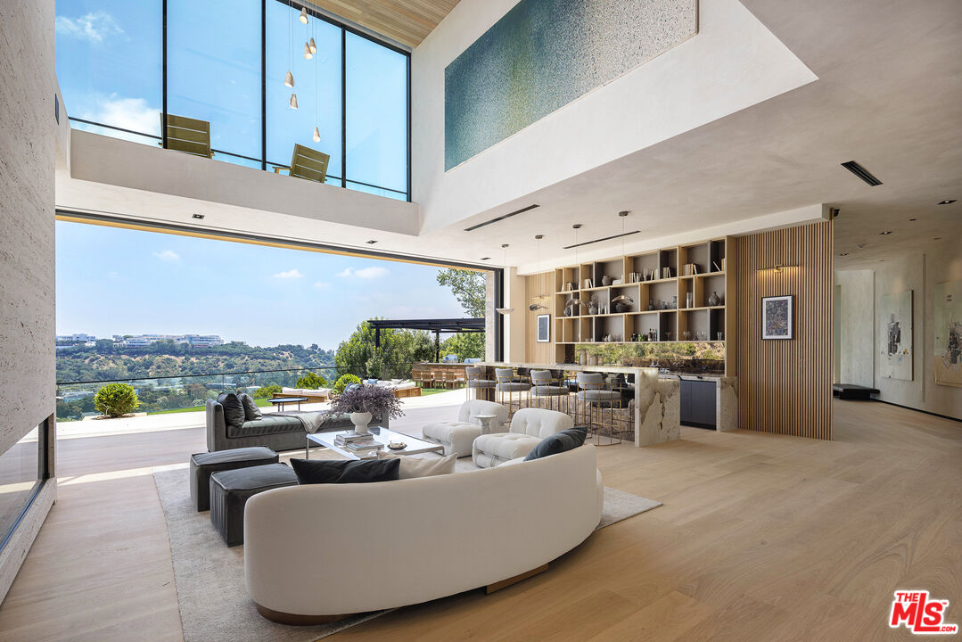 1104 North Tigertail Road Los Angeles, CA 90049 - Photo 4 of 27 a living room with furniture and a large window