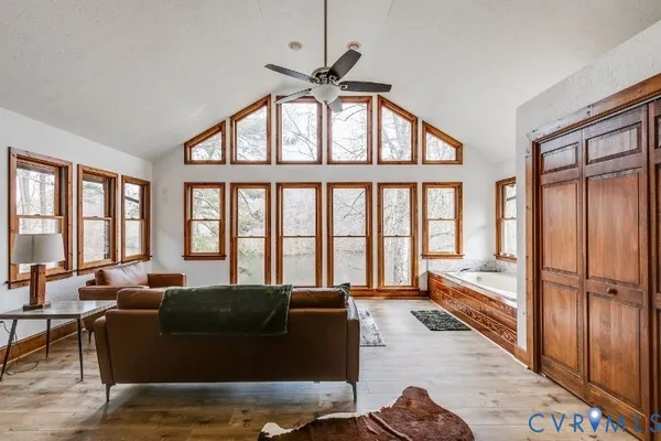 a living room with furniture ceiling fan and a window