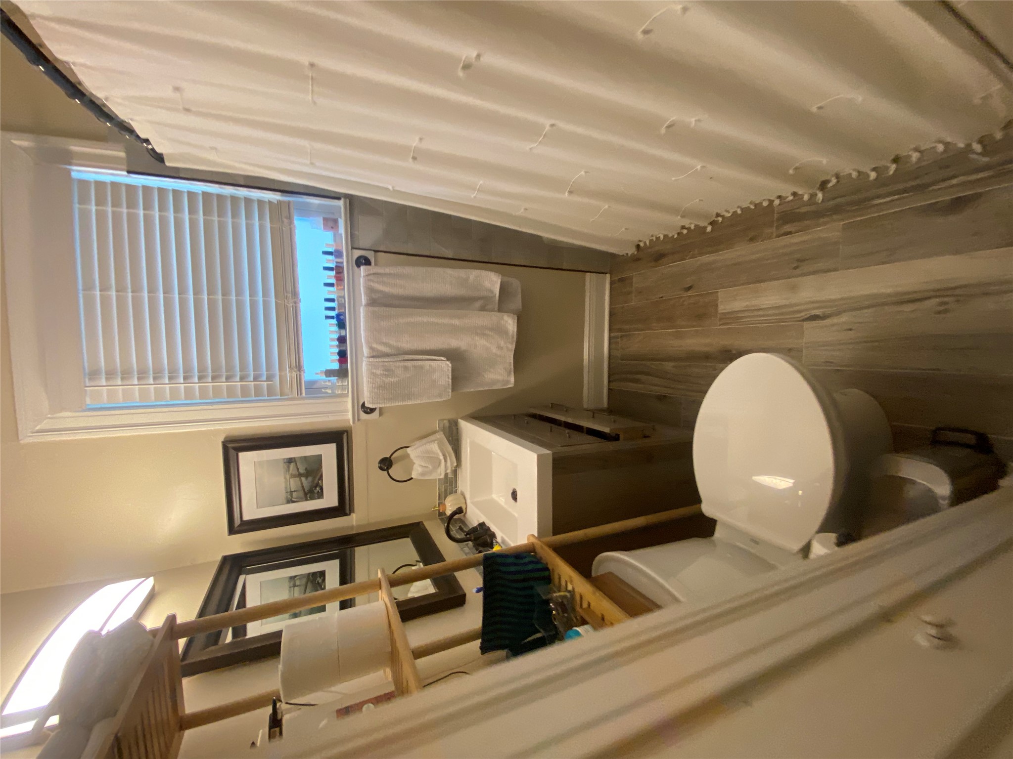3010 Fruth Street, Unit A Austin, TX 78705 - Photo 29 of 39 Contemporary bathroom featuring wood-finish flooring, a white vanity with an integrated sink, and a window with white blinds