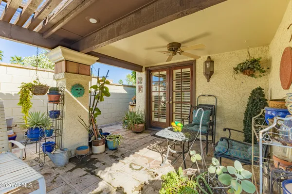 a view of a patio with table and chairs potted plants