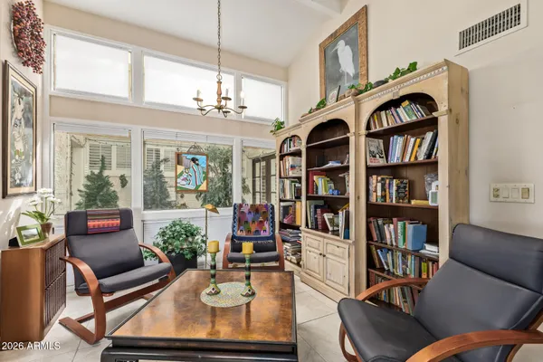a living room with fireplace furniture and a book shelf