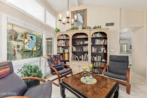 a living room with furniture and a chandelier