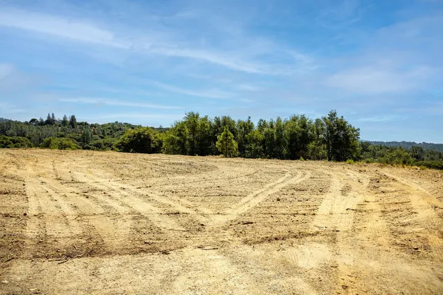a view of a large mountain with mountains in the background
