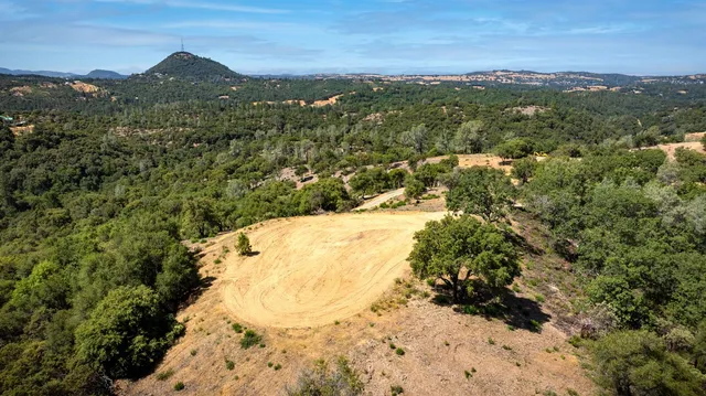 a view of a yard with a mountain