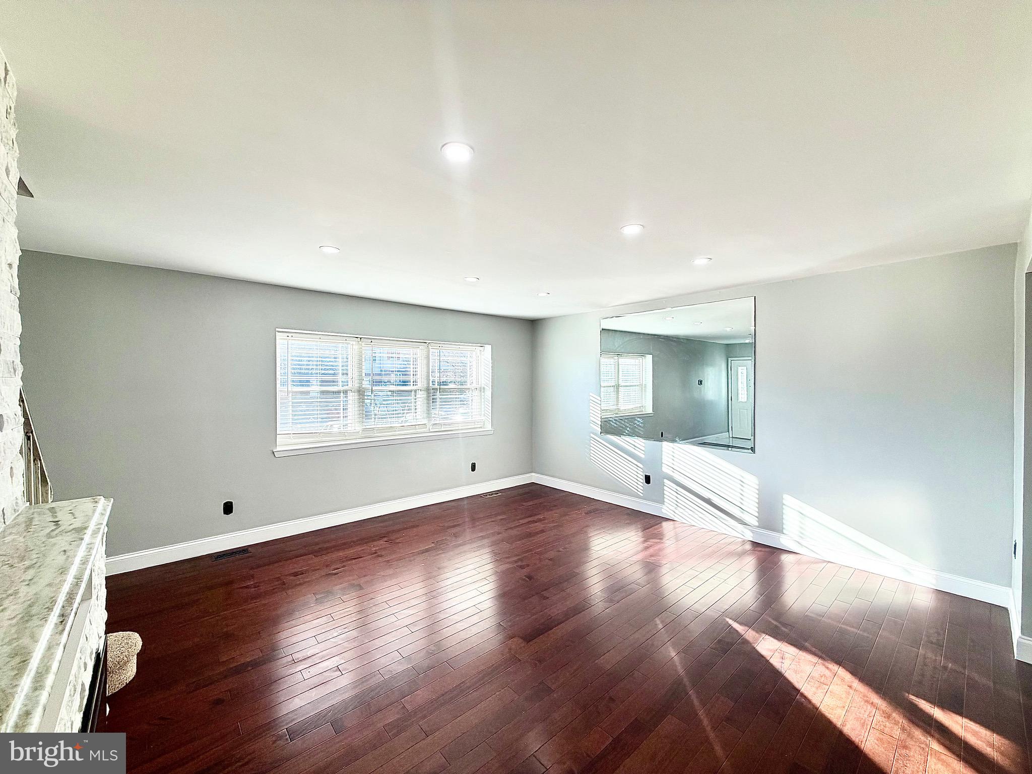 1 Broadleaf Court Baltimore, MD 21234 - Photo 3 of 35 a view of an empty room with wooden floor and a window