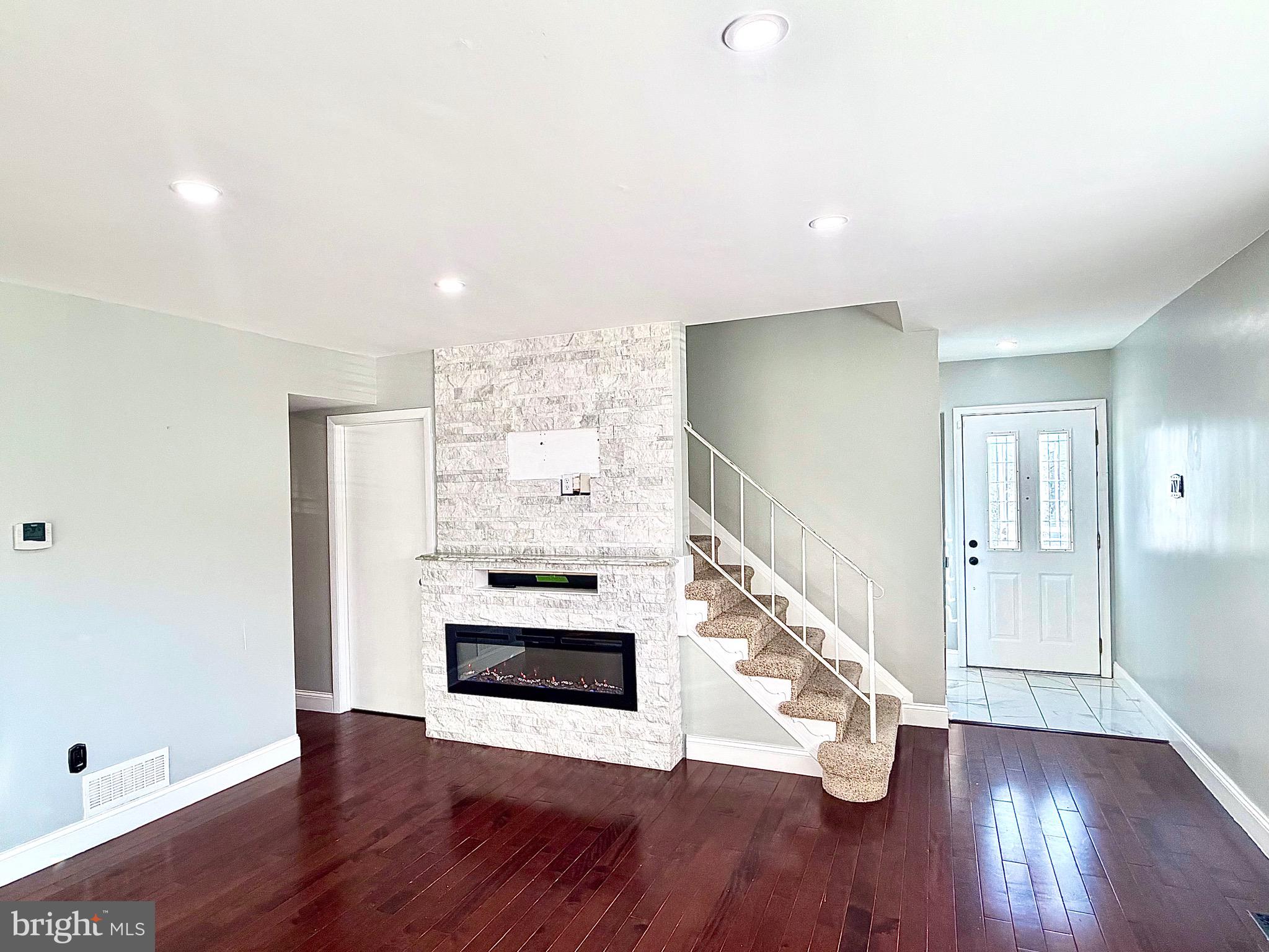 1 Broadleaf Court Baltimore, MD 21234 - Photo 4 of 35 a view of an empty room with wooden floor fireplace and a window