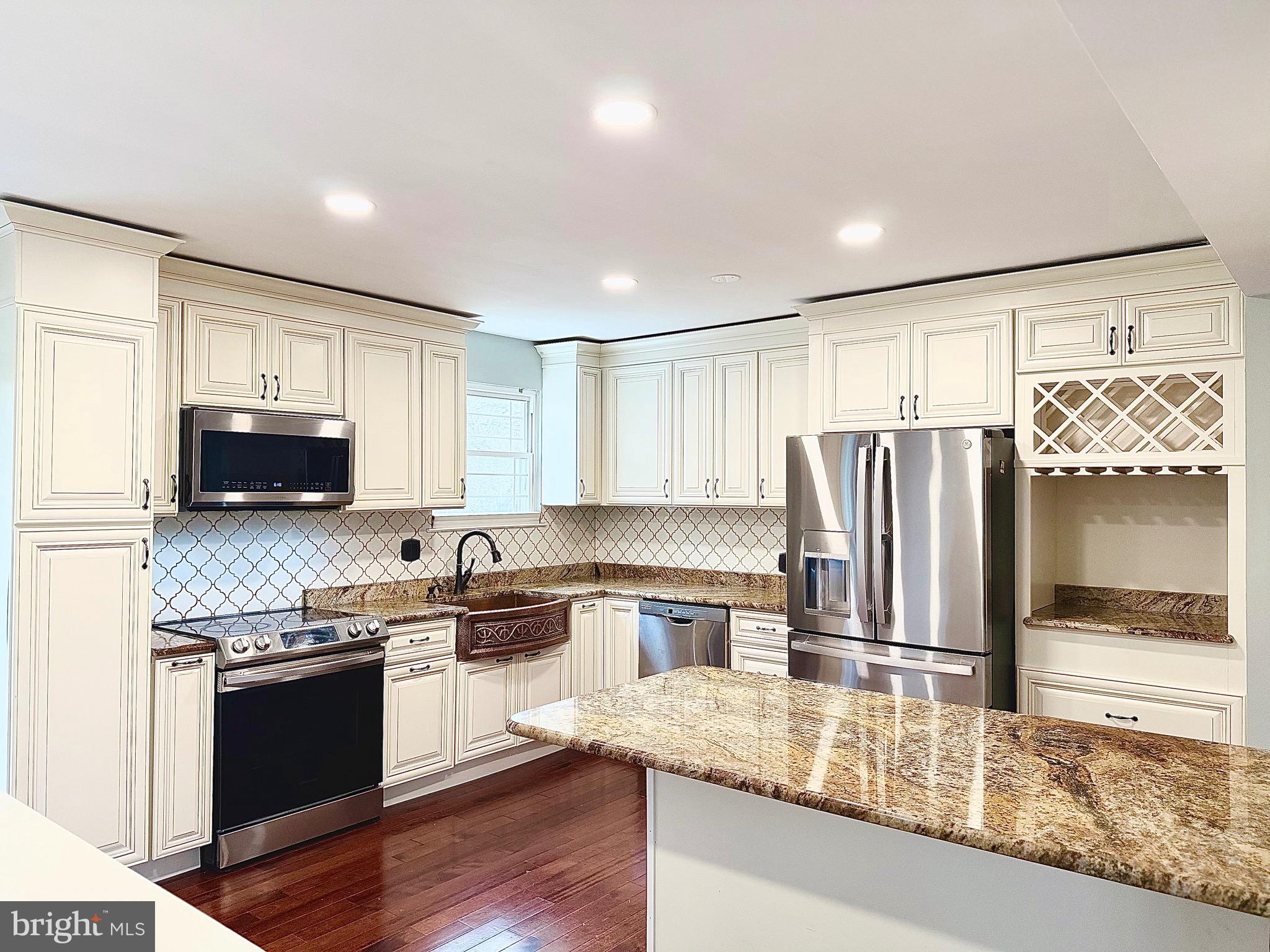 1 Broadleaf Court Baltimore, MD 21234 - Photo 7 of 35 a kitchen with stainless steel appliances granite countertop a refrigerator a stove a sink and a microwave