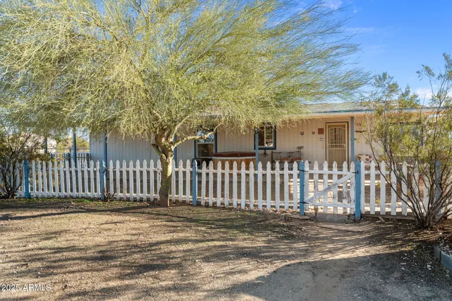 a view of a house with a fence