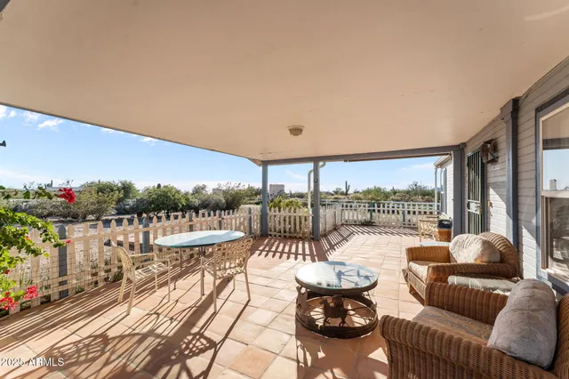a balcony with furniture and a floor to ceiling window
