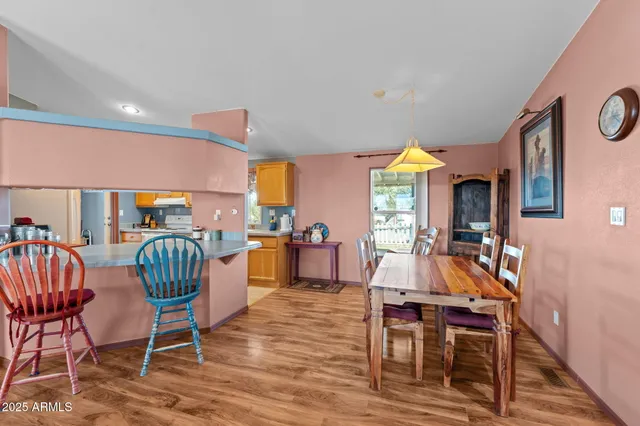 a dining room with furniture window and wooden floor
