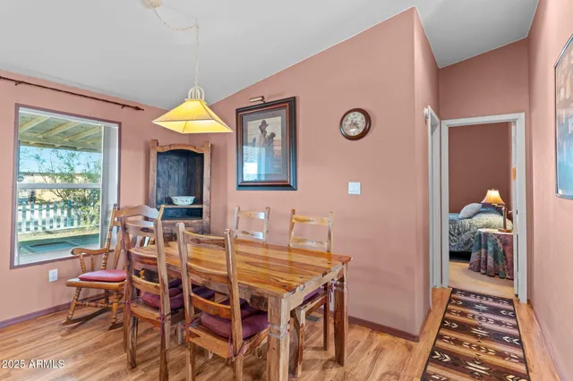 a view of a dining room with furniture and a window