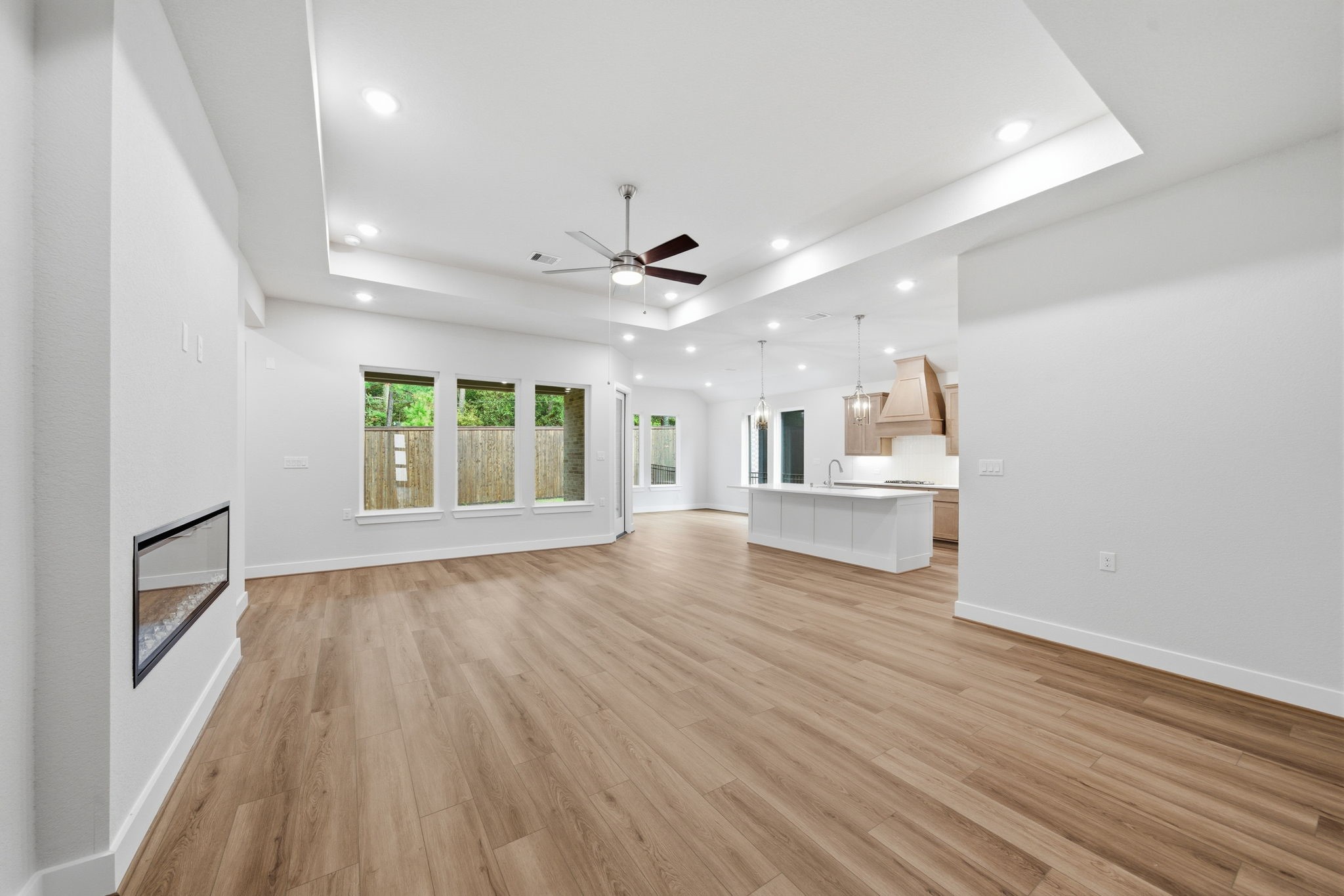 10026 Larkin Cove Willis, TX 77318 - Photo 4 of 46 an empty room with wooden floor and windows