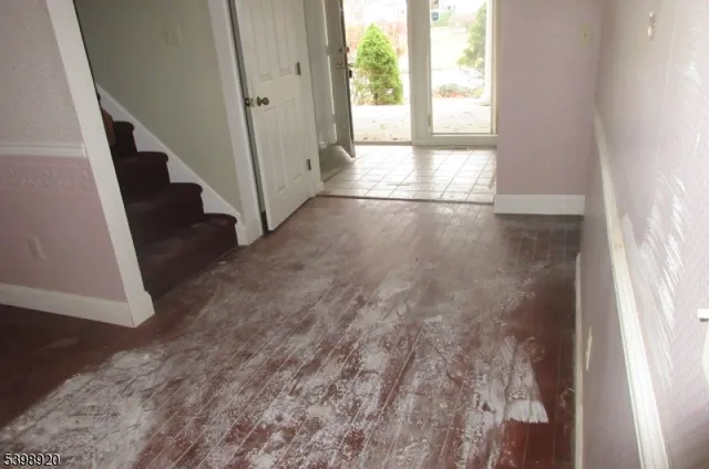 a view of an entryway with wooden floor