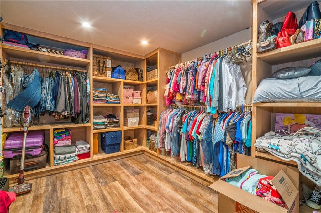 7084 Bartosch Road Robstown, TX 78380 - Photo 19 of 35 a view of walk in closet with clothes and shoes