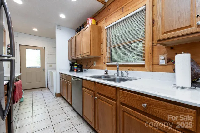 a kitchen with granite countertop a sink and a stove