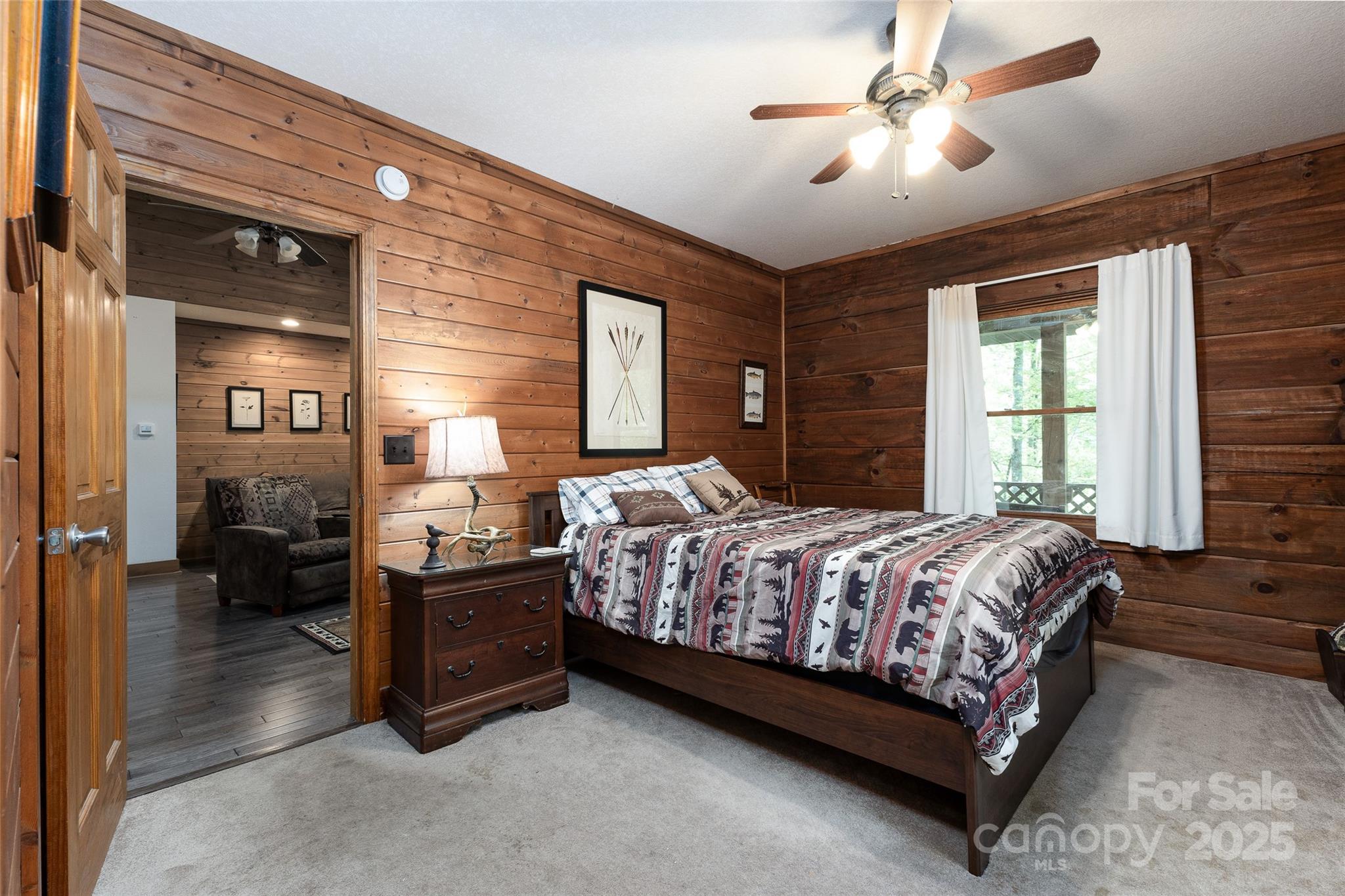 242 Eagles Roost Road Bryson City, NC 28713 - Photo 17 of 33 a bedroom with a bed and a chandelier