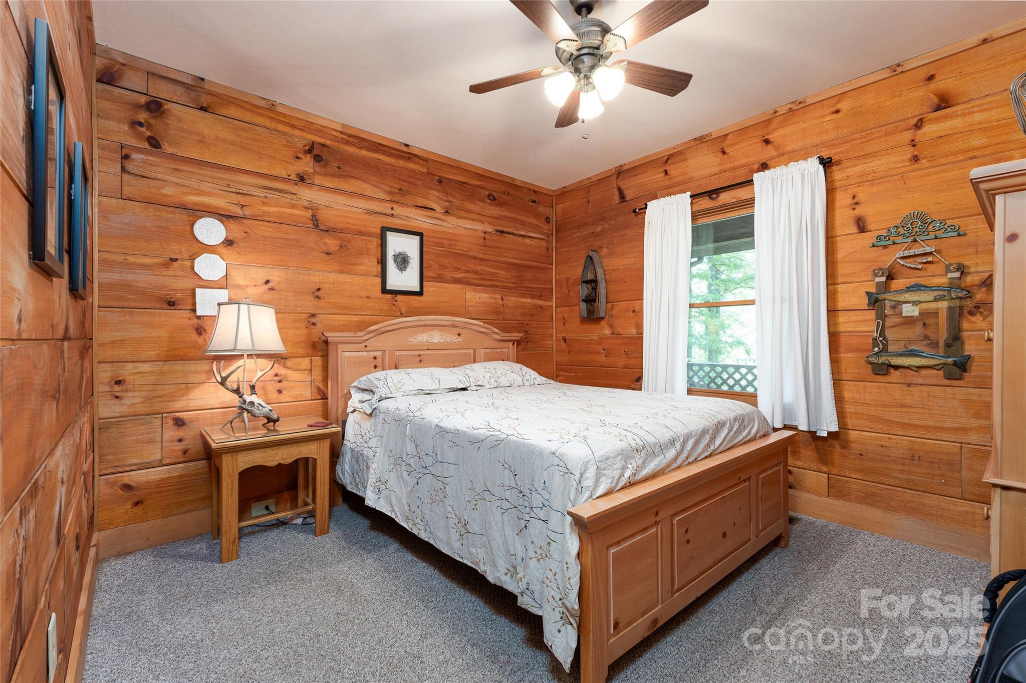 242 Eagles Roost Road Bryson City, NC 28713 - Photo 20 of 33 a bedroom with a bed and a chandelier