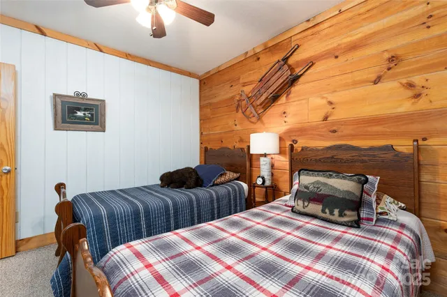a bedroom with two beds and painting on the wall