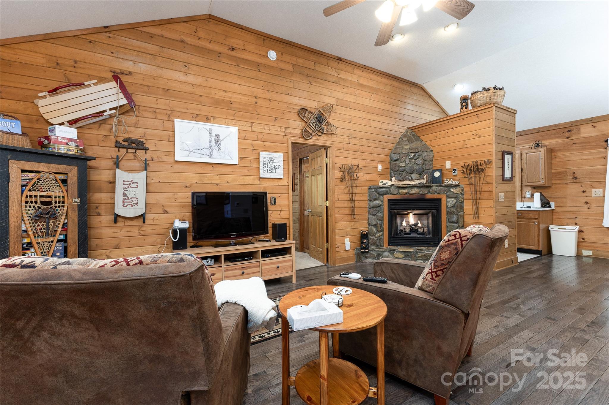 242 Eagles Roost Road Bryson City, NC 28713 - Photo 9 of 33 a living room with fireplace furniture and a flat screen tv