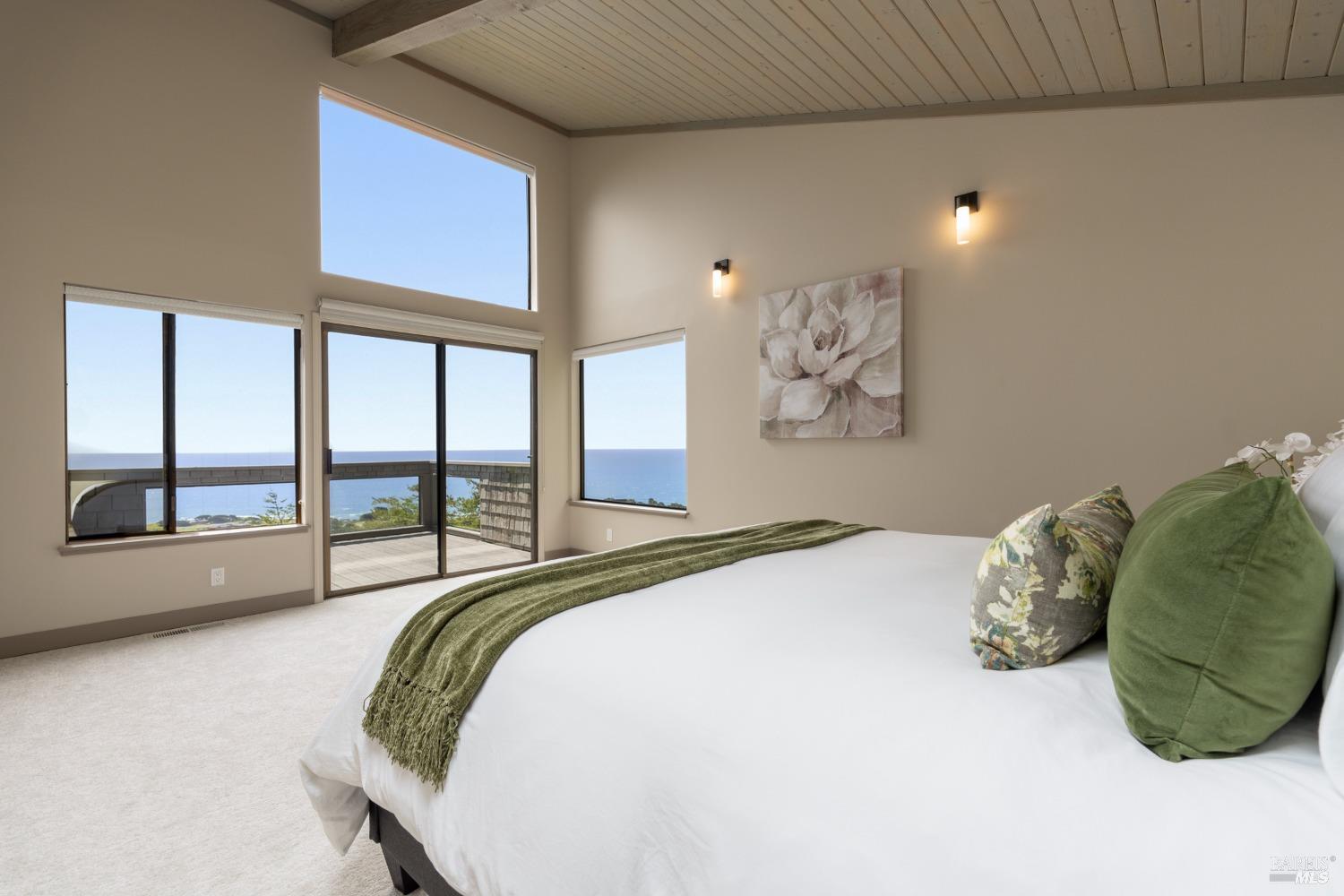 Undisclosed Address The Sea Ranch, CA 95497 - Photo 11 of 46 a spacious bedroom with a bed and a large window