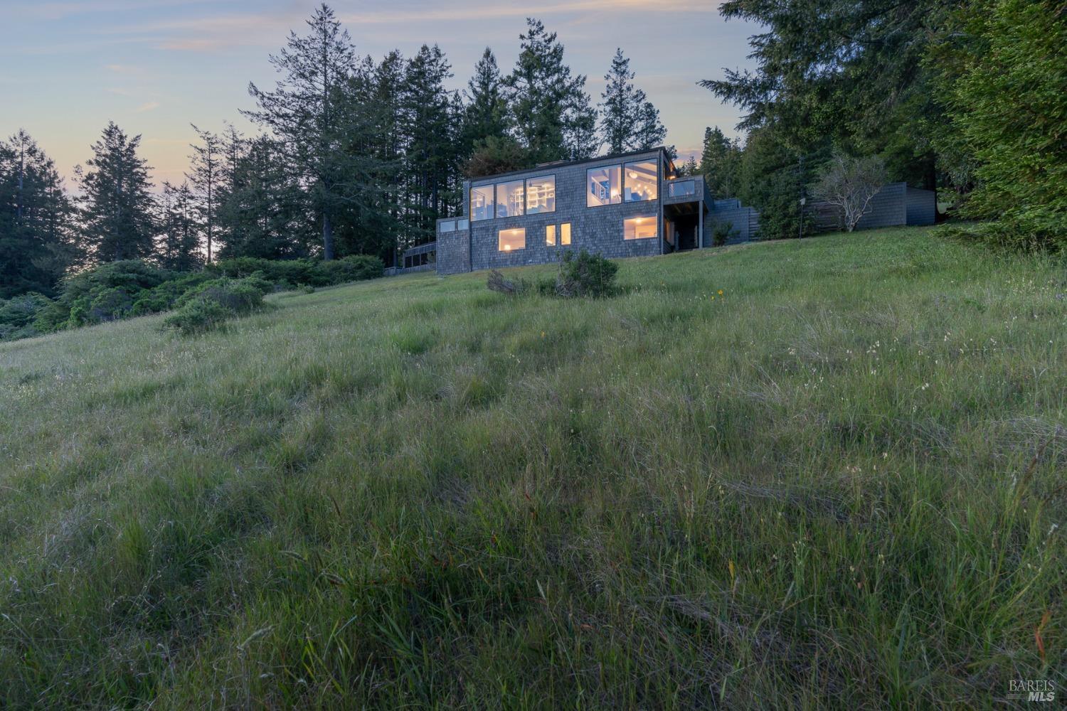 Undisclosed Address The Sea Ranch, CA 95497 - Photo 23 of 46 a view of a big house with a big yard and large trees