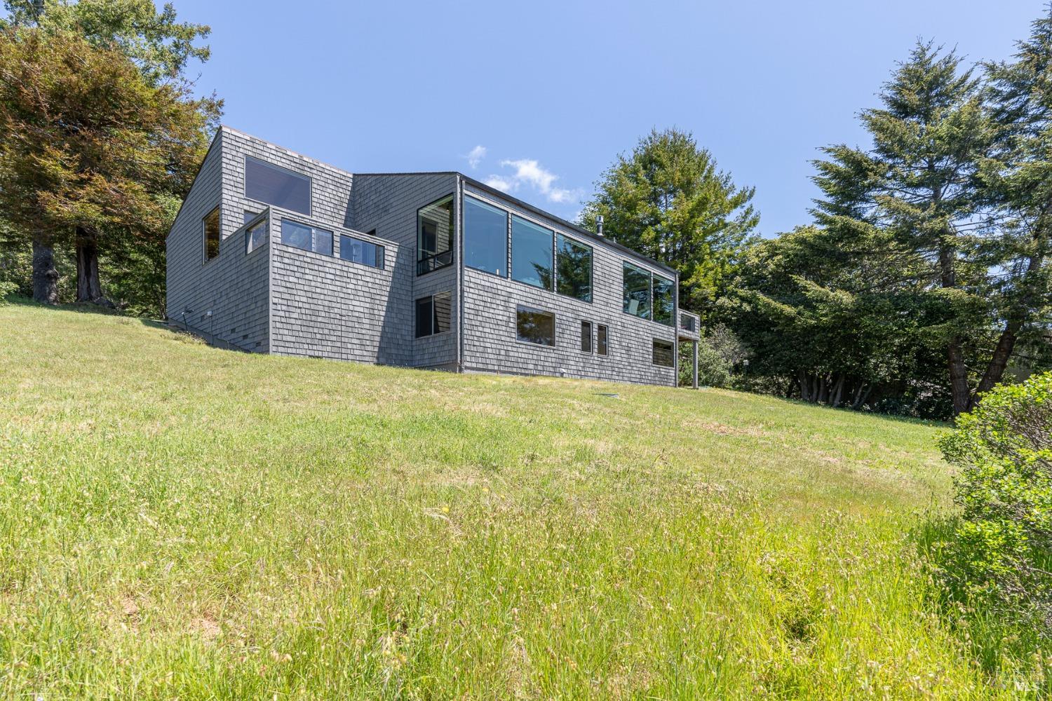 Undisclosed Address The Sea Ranch, CA 95497 - Photo 25 of 46 a yellow house with a yard in front of it