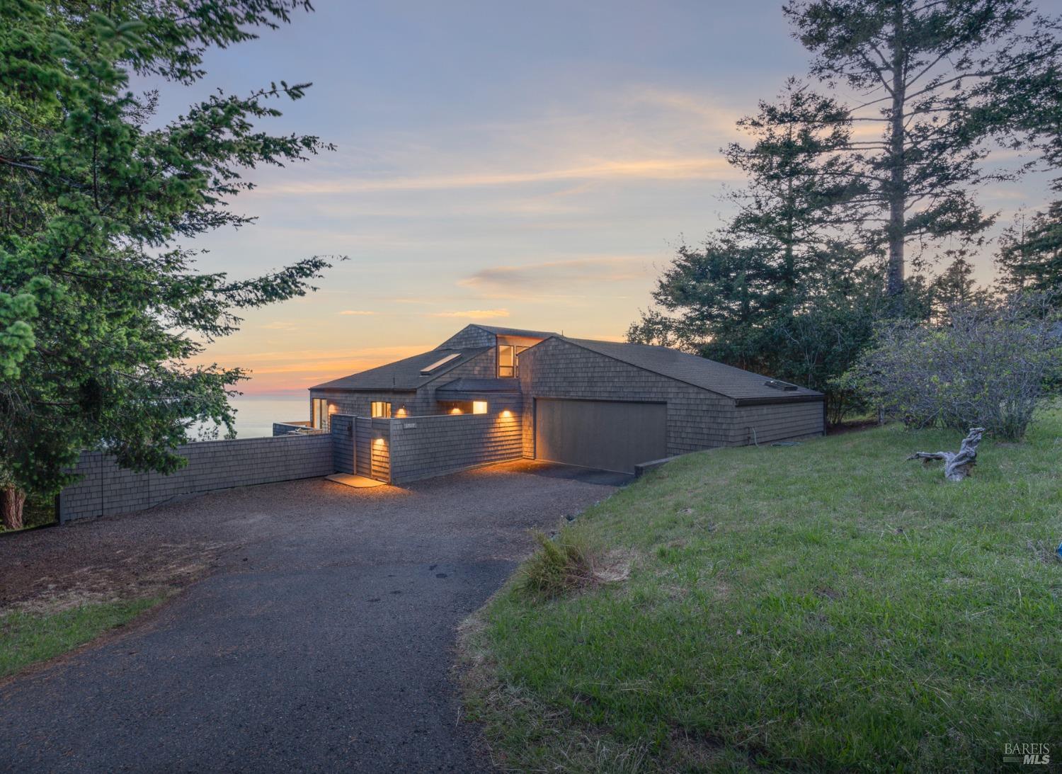 Undisclosed Address The Sea Ranch, CA 95497 - Photo 3 of 46 a view of a large house with a big yard and large trees