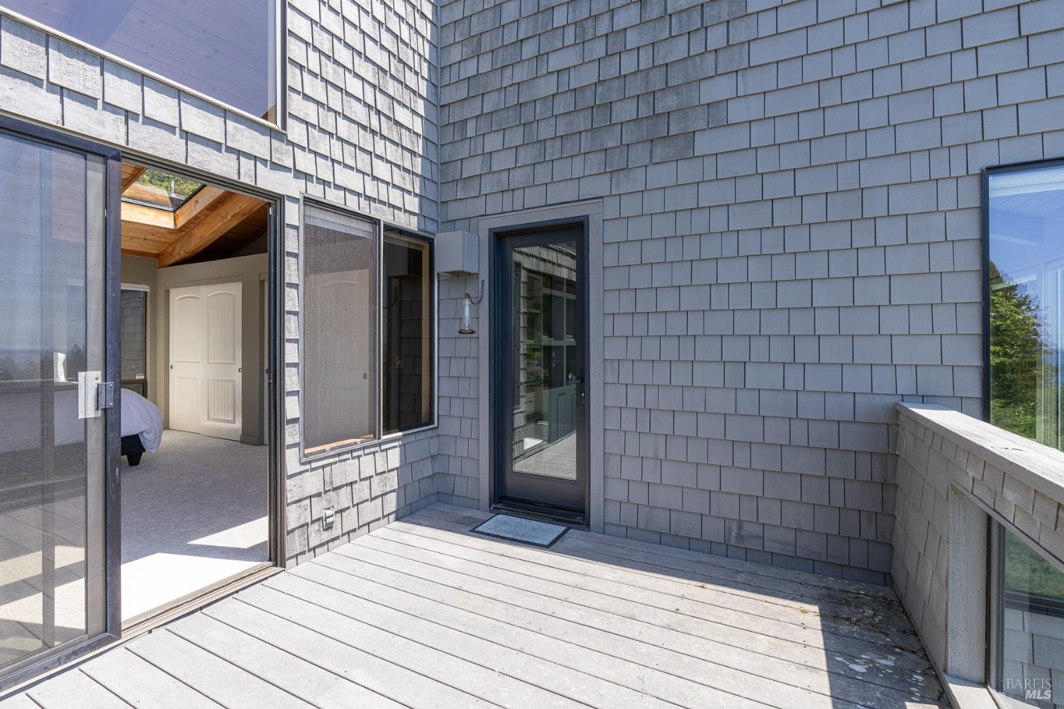 Undisclosed Address The Sea Ranch, CA 95497 - Photo 35 of 46 a view of a brick house with a wooden bench