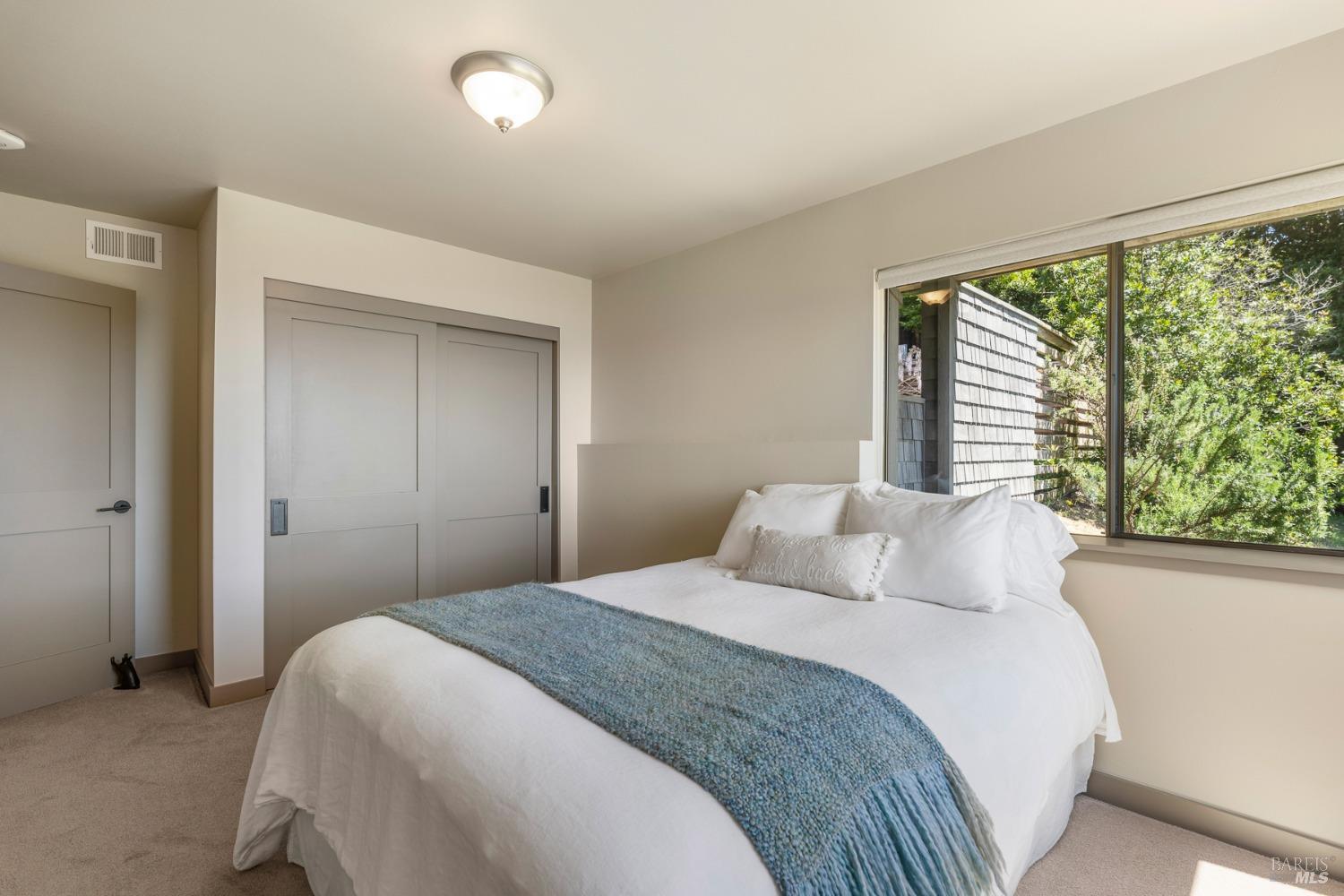 Undisclosed Address The Sea Ranch, CA 95497 - Photo 38 of 46 a bedroom with a large bed and a large window