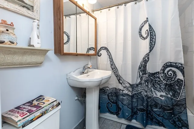 a bathroom with a sink and mirror with window