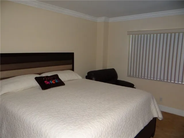 a bedroom with bed and a night stand