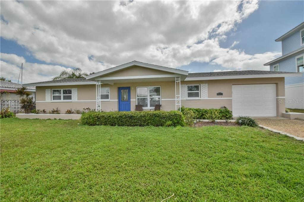 405 173rd Avenue North Redington Beach, FL 33708 - Photo 1 of 1 a front view of house with yard and green space