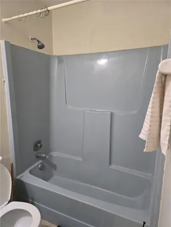 a bathroom with a tub and a shower