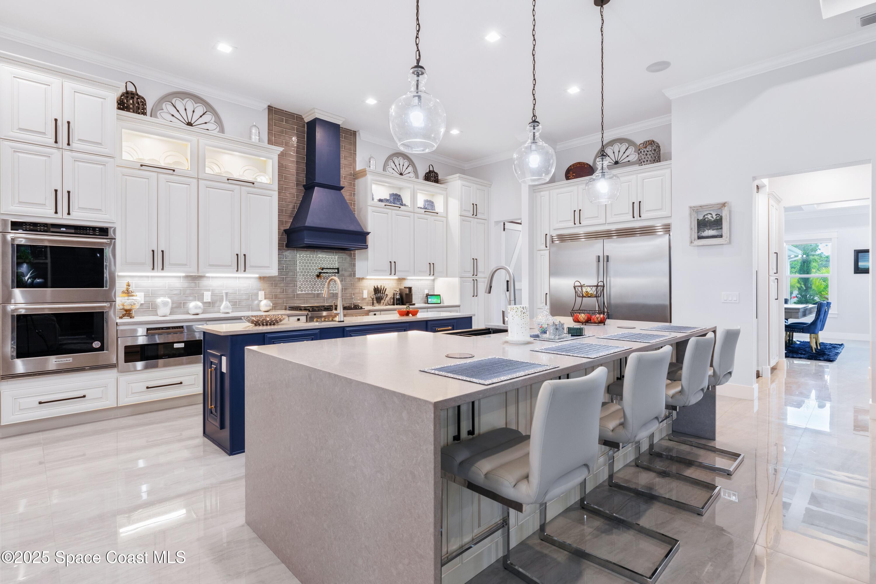 1420 Corey Road Malabar, FL 32950 - Photo 11 of 35 a kitchen with stainless steel appliances kitchen island granite countertop a sink and a stove