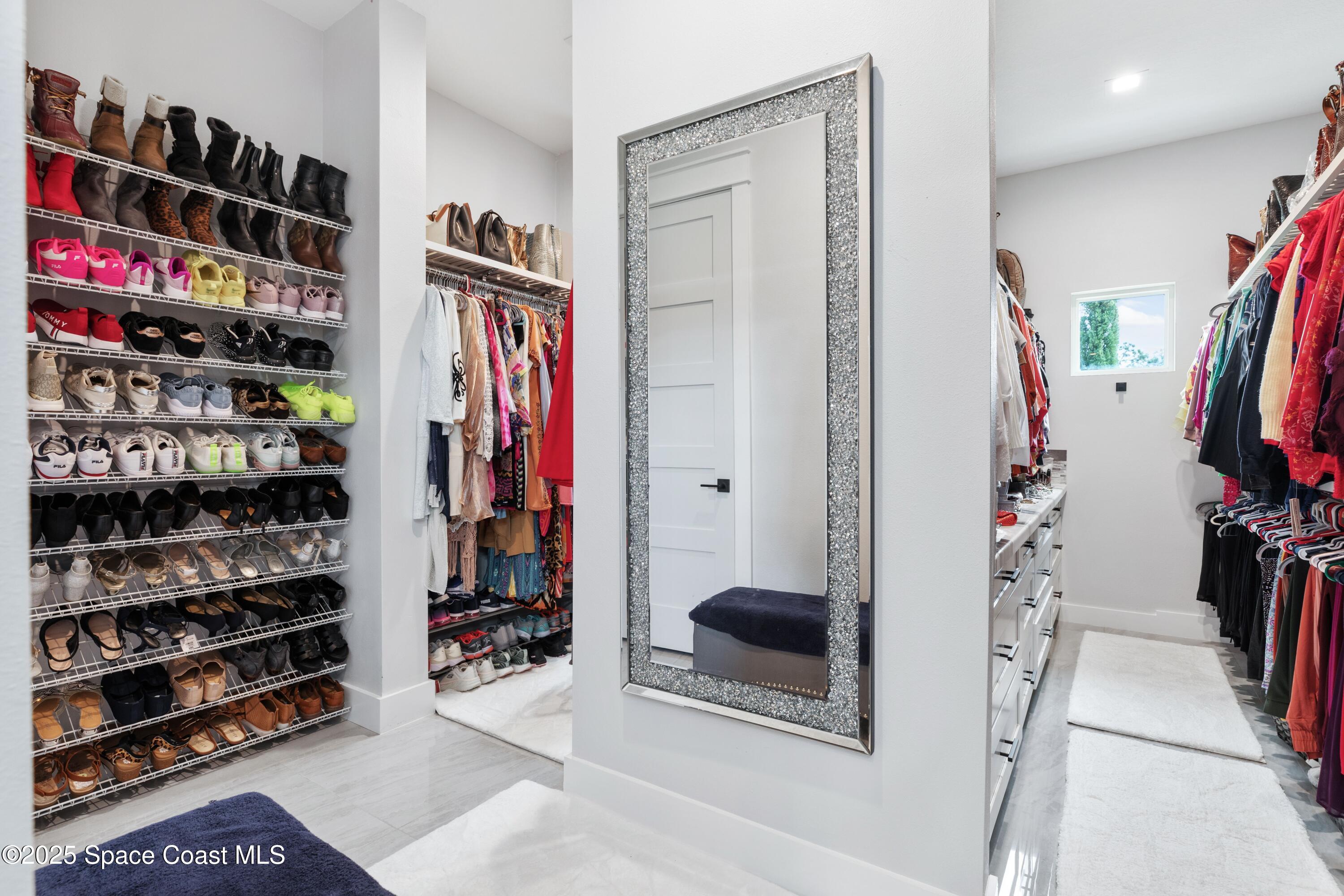 1420 Corey Road Malabar, FL 32950 - Photo 20 of 35 a view of walk in closet with clothes and shoes