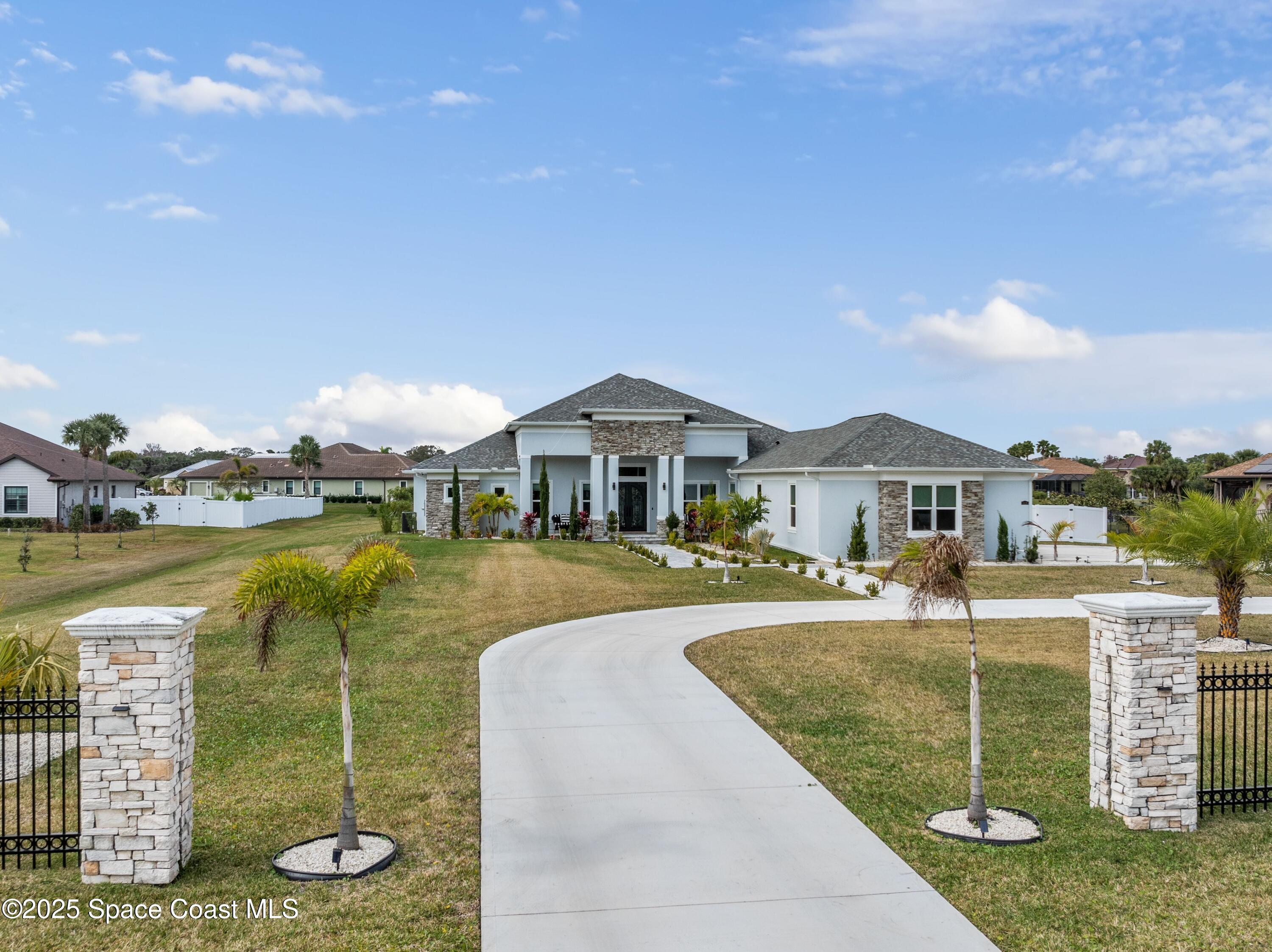 1420 Corey Road Malabar, FL 32950 - Photo 2 of 35 a front view of a house with swimming pool having outdoor seating