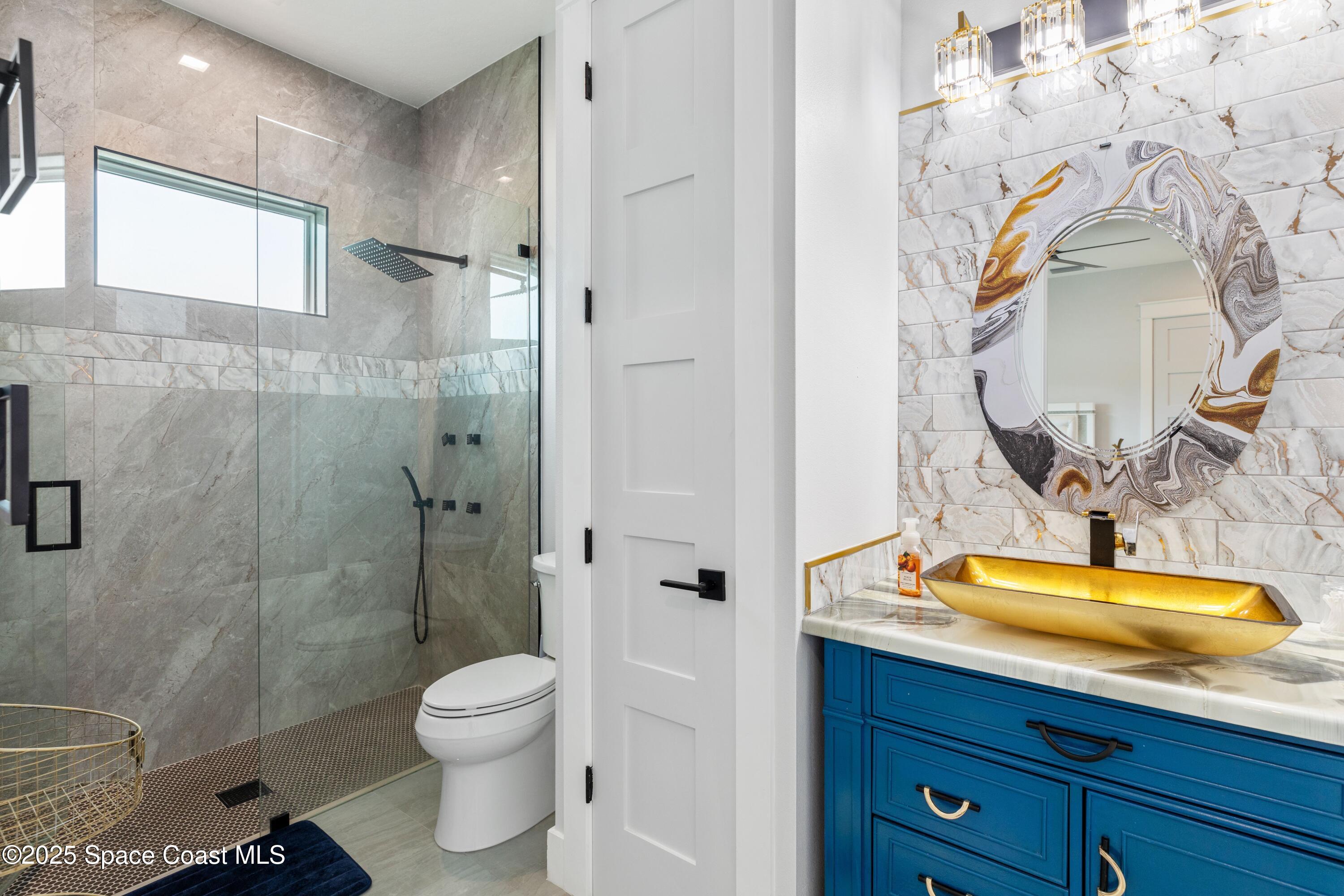 1420 Corey Road Malabar, FL 32950 - Photo 24 of 35 a bathroom with a sink a toilet and shower