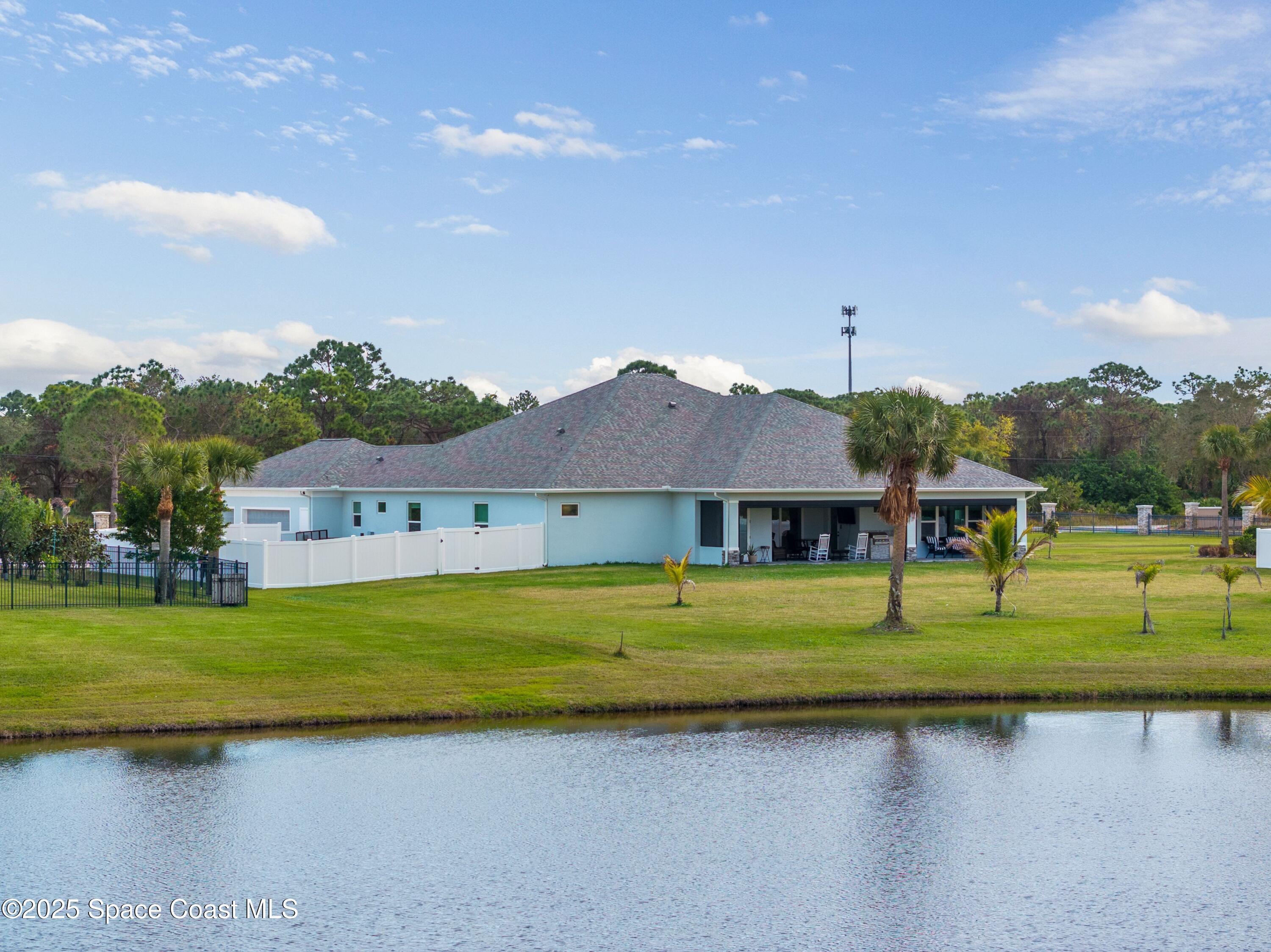 1420 Corey Road Malabar, FL 32950 - Photo 29 of 35 a front view of a house with a garden and yard