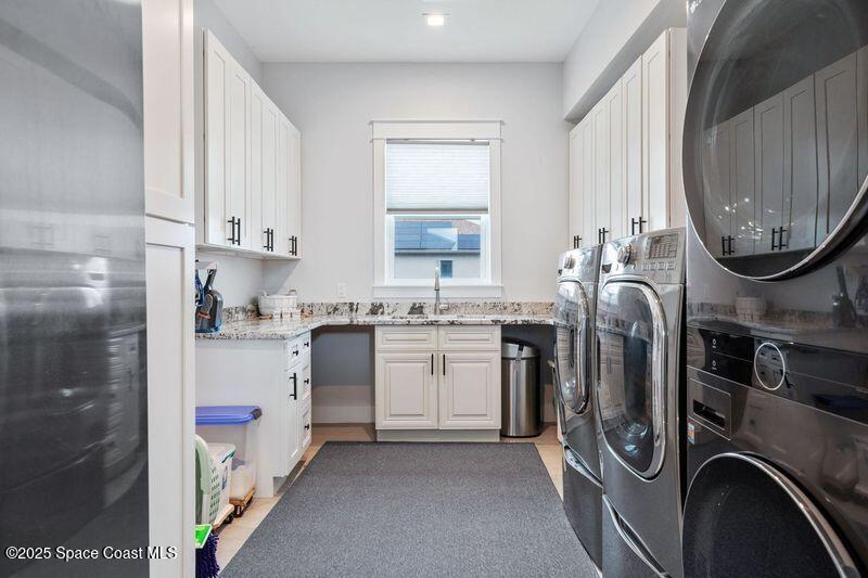 1420 Corey Road Malabar, FL 32950 - Photo 30 of 35 a utility room with sink dryer and washer